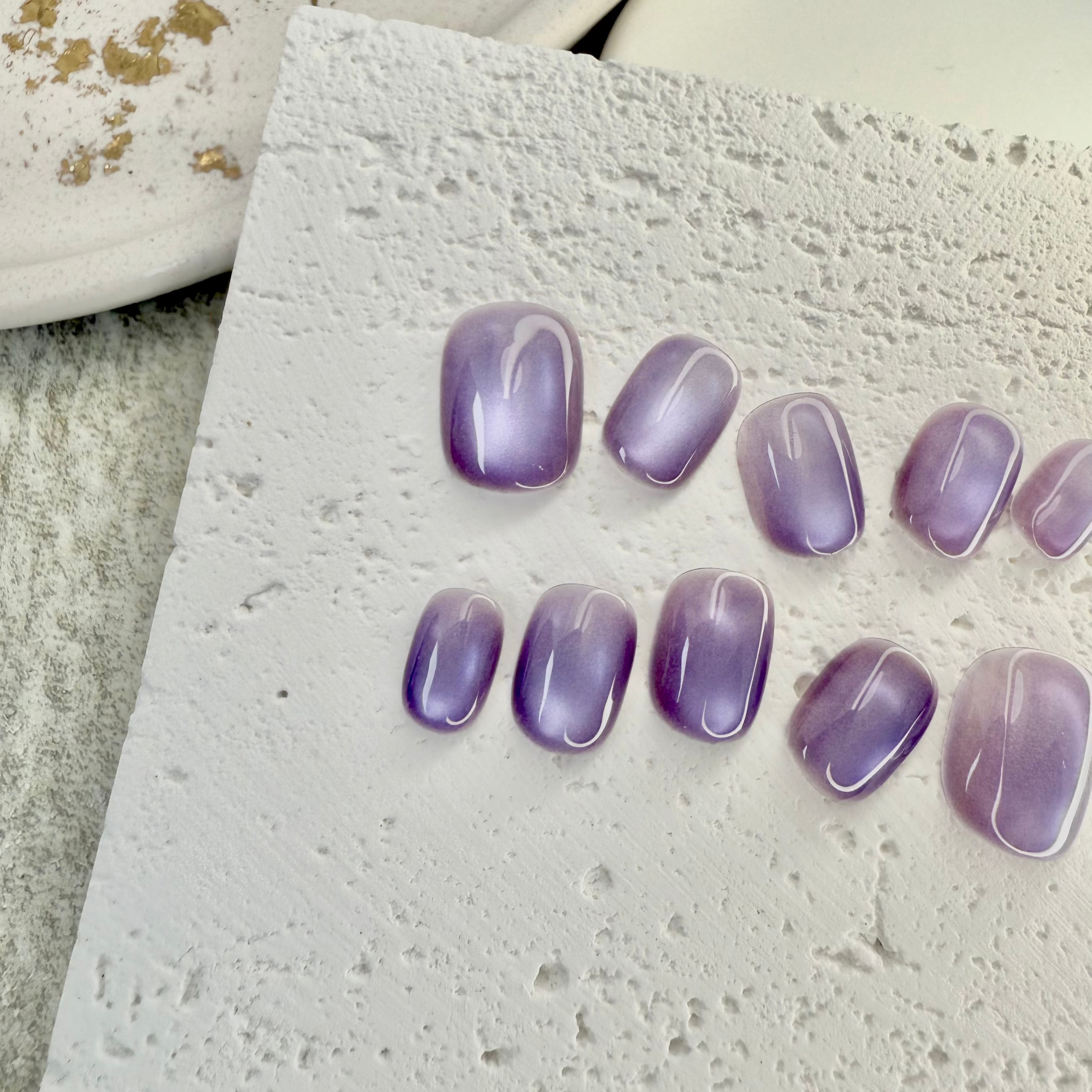 Violet Mist cat eye press-on nails in soft purple with magnetic shimmer effect