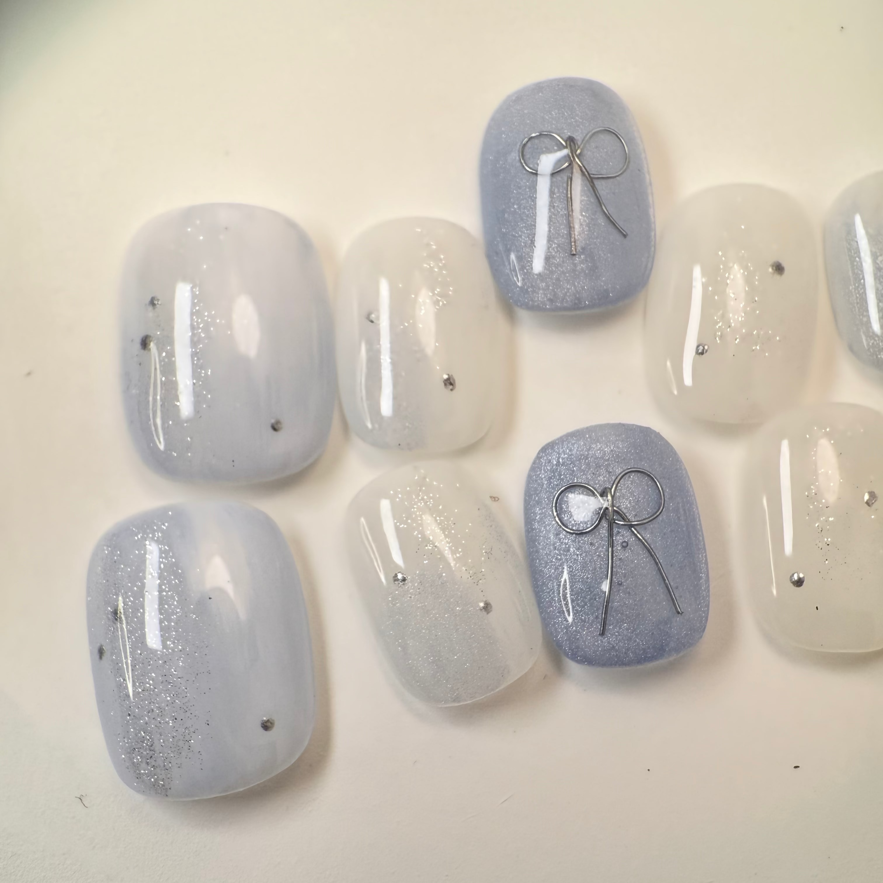 Handmade round golden cat-eye press-on nails with shimmering magnetic effect, Vlei Nails Cape Town.