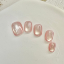 Rose Starlight cat eye press-on nails with soft pink shimmer and magnetic glow