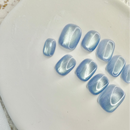 Ocean Whisper cat eye press-on nails in soft blue with magnetic shimmer effect