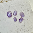 Violet Mist cat eye press-on nails in soft purple with magnetic shimmer effect