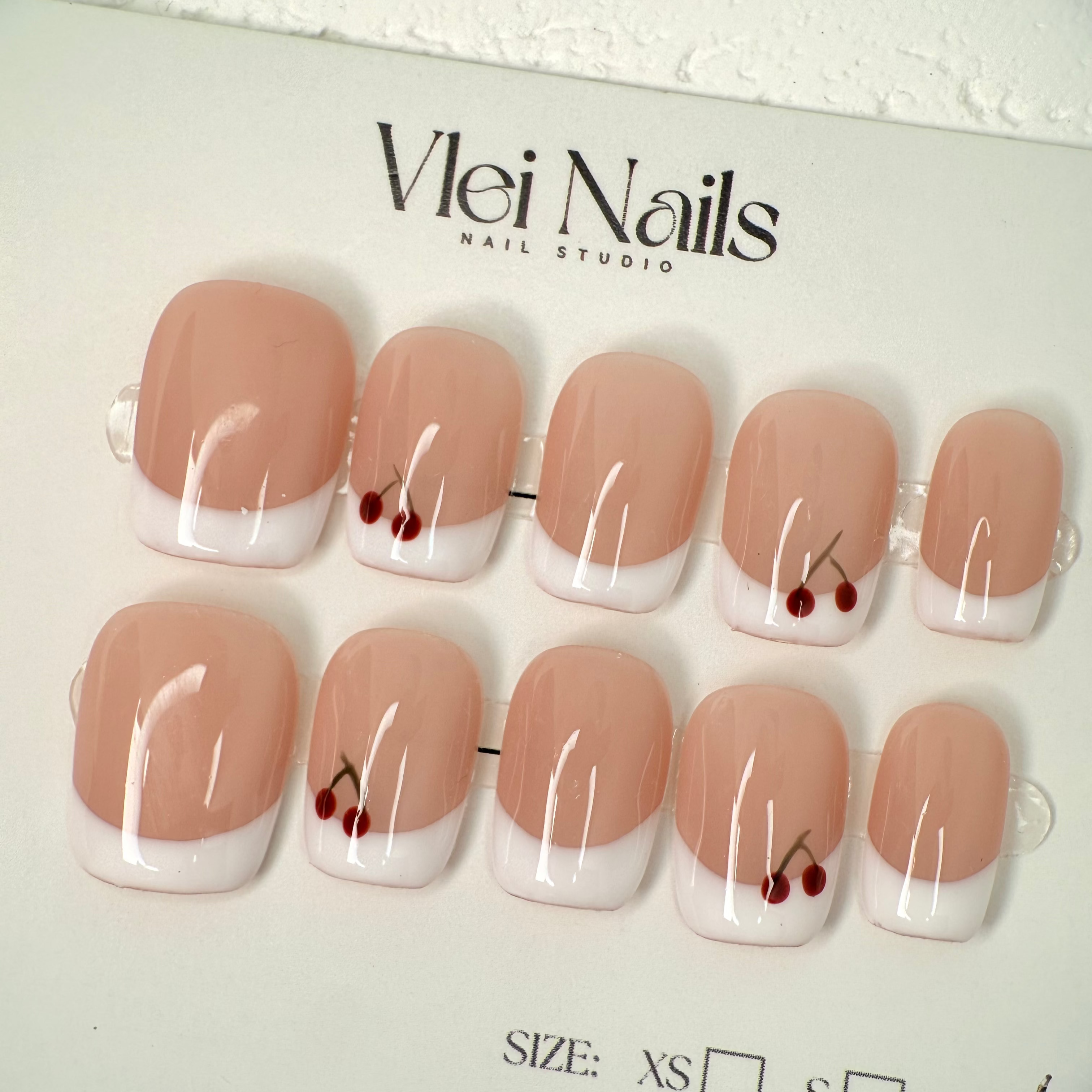 	•	Cherry French press-on nails with red French tips
