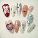3D jelly bear and ribbon themed press-on nails in silver, pink, and nude tones with stars, cherries, and metallic heart details – handcrafted by Vlei Nails Cape Town.
