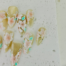 Handcrafted pink press-on nails with gold foil and pearl accents, soft shimmer finish – made by Vlei Nails Cape Town.
