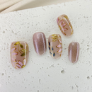 Handcrafted nude pink and gold cat-eye press-on nails with 3D gold line accents – made by Vlei Nails Cape Town.
