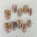 Handcrafted nude pink and gold cat-eye press-on nails with 3D gold line accents – made by Vlei Nails Cape Town.
