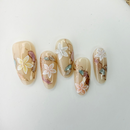 Handcrafted blush nude press-on nails with pearl flowers and gold shimmer lines – made by Vlei Nails Cape Town.
