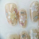 Handcrafted blush nude press-on nails with pearl flowers and gold shimmer lines – made by Vlei Nails Cape Town.
