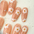 Handcrafted nude pink press-on nails with 3D pearl flowers and gold foil shimmer – made by Vlei Nails Cape Town.
