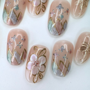 Handcrafted ivory white press-on nails with 3D pearl flowers and gold shimmer – made by Vlei Nails Cape Town.
