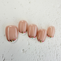 Christmas-themed French press-on nails with white tips and subtle shimmer, elegant handmade holiday nails by Vlei Nails.
