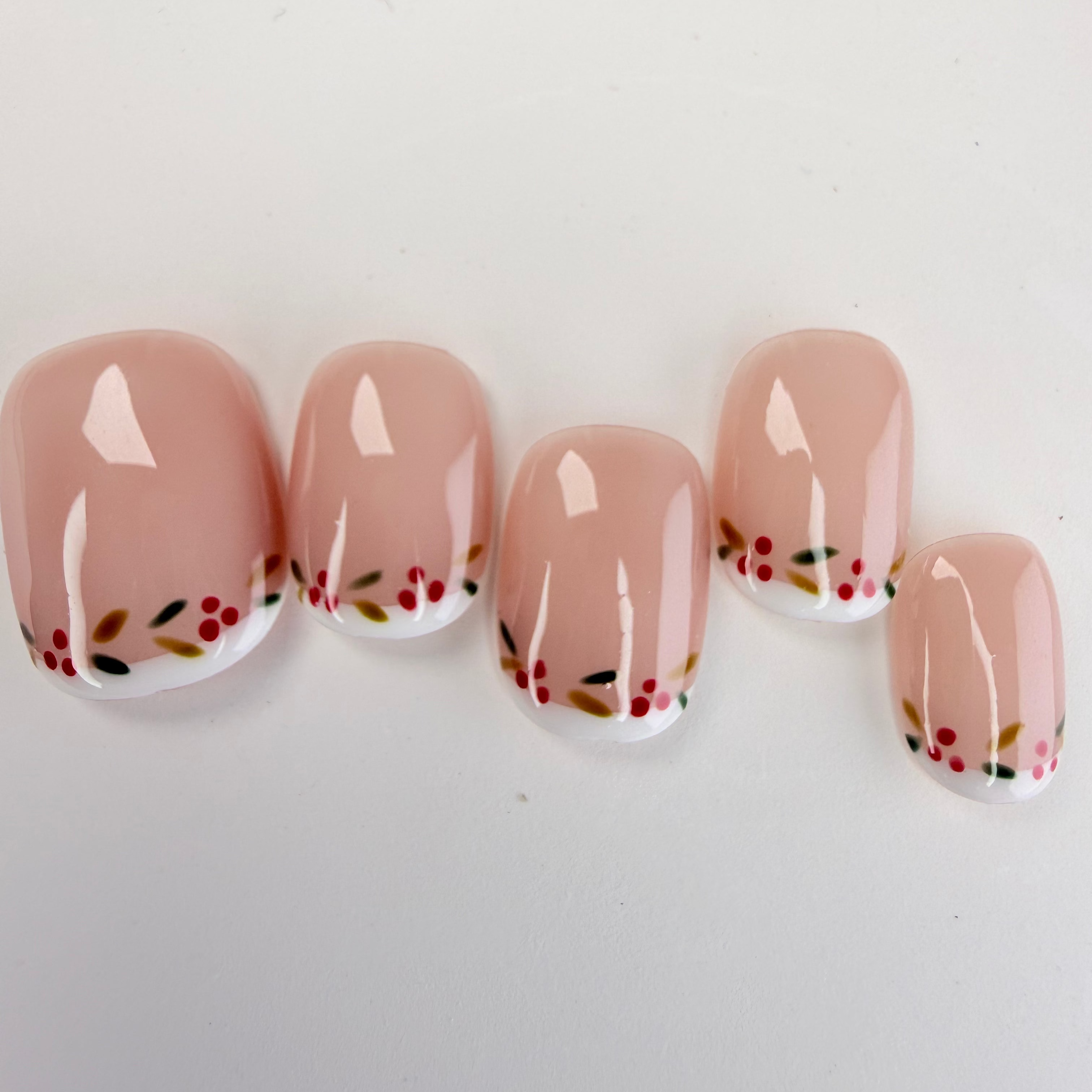 Christmas-themed French press-on nails with white tips and subtle shimmer, elegant handmade holiday nails by Vlei Nails.
