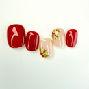 Christmas press-on nails with red and nude tones, decorated with hand-painted holly leaves and berries — festive handmade holiday nails by Vlei Nails.
