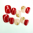 Christmas press-on nails with red and nude tones, decorated with hand-painted holly leaves and berries — festive handmade holiday nails by Vlei Nails.
