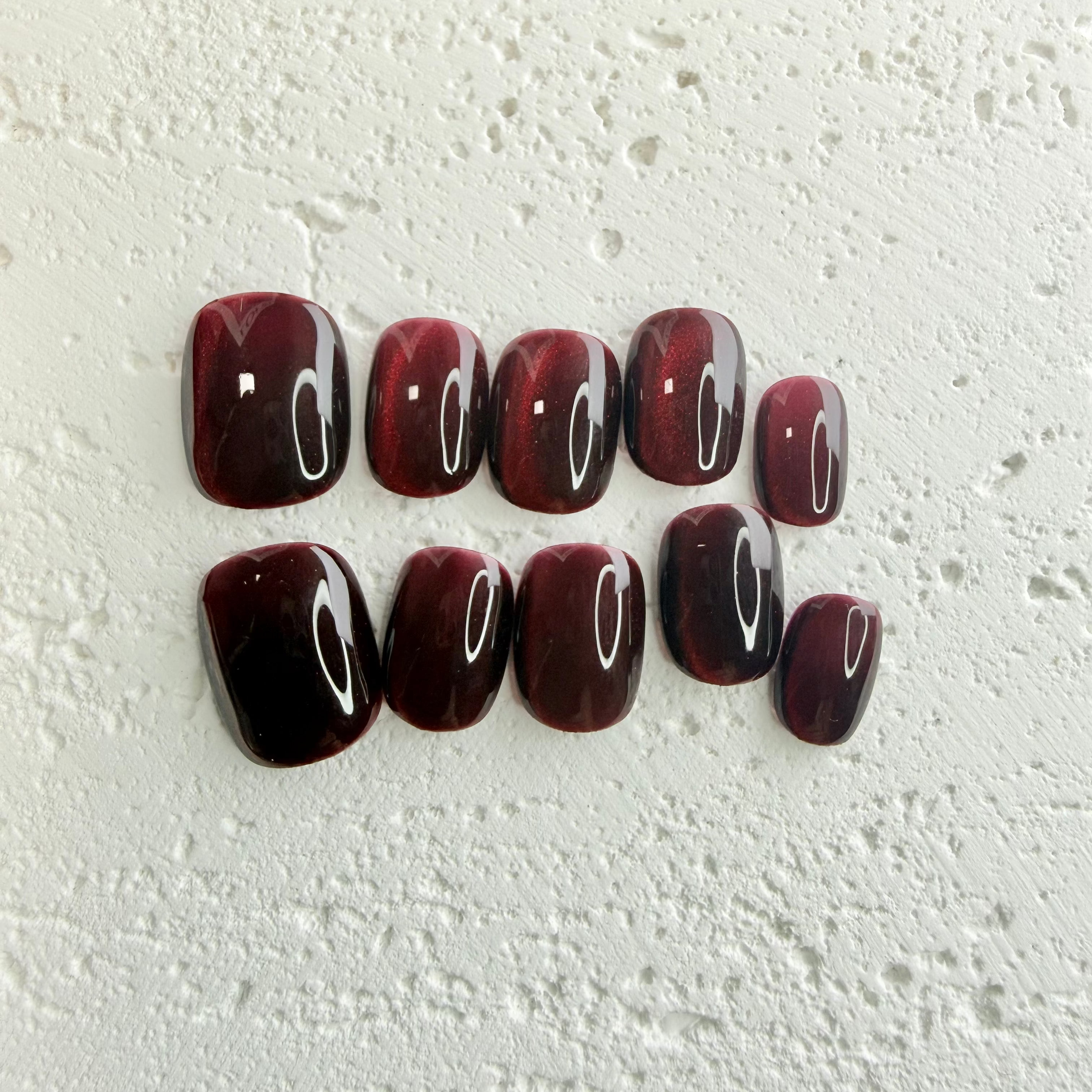 Handmade deep red press-on nail set with a jewel-like shine