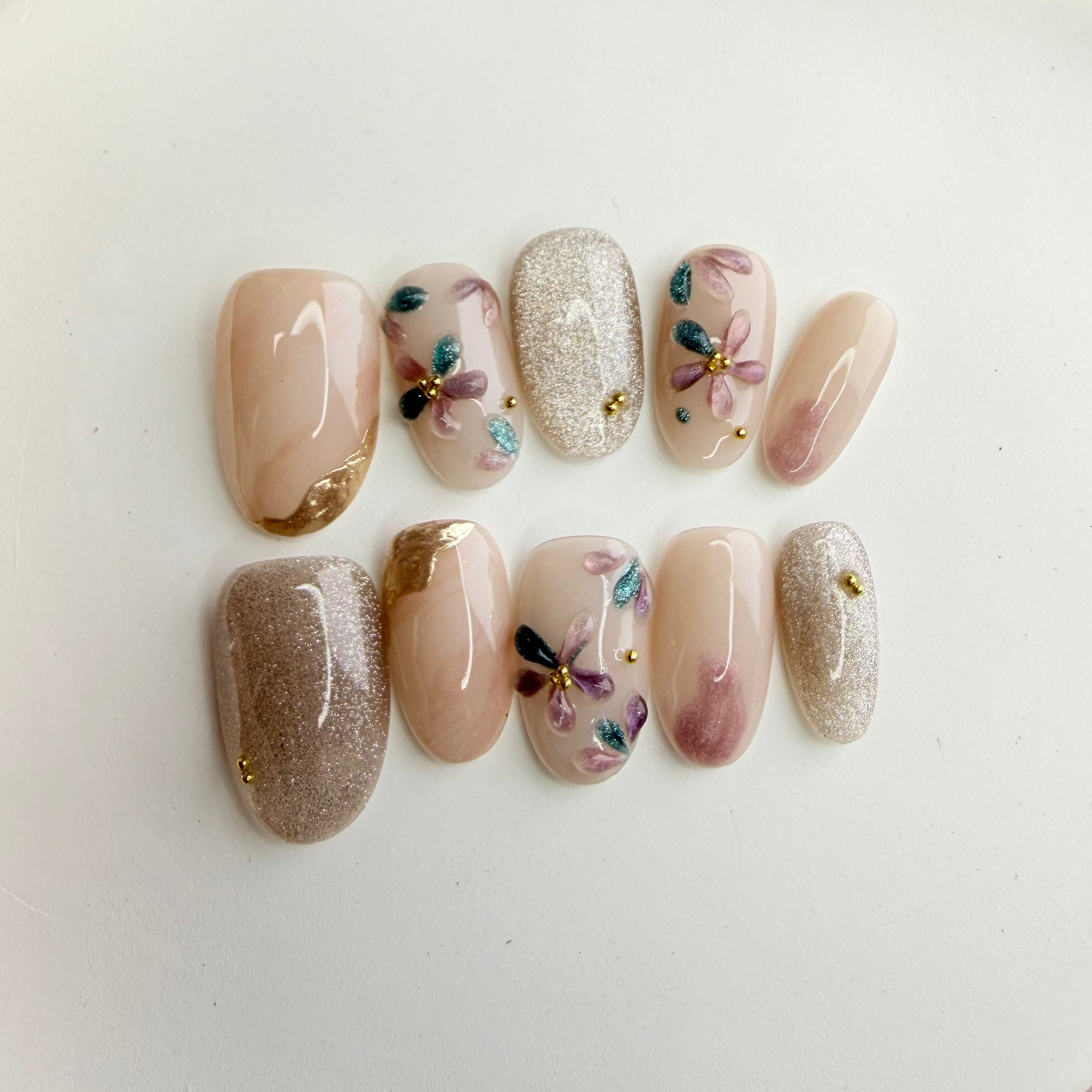 pastel flower nude press-on nails with silver glitter accent, handcrafted gel nails on white plate, Vlei Nails South Africa