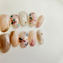 pastel flower nude press-on nails with silver glitter accent, handcrafted gel nails on white plate, Vlei Nails South Africa