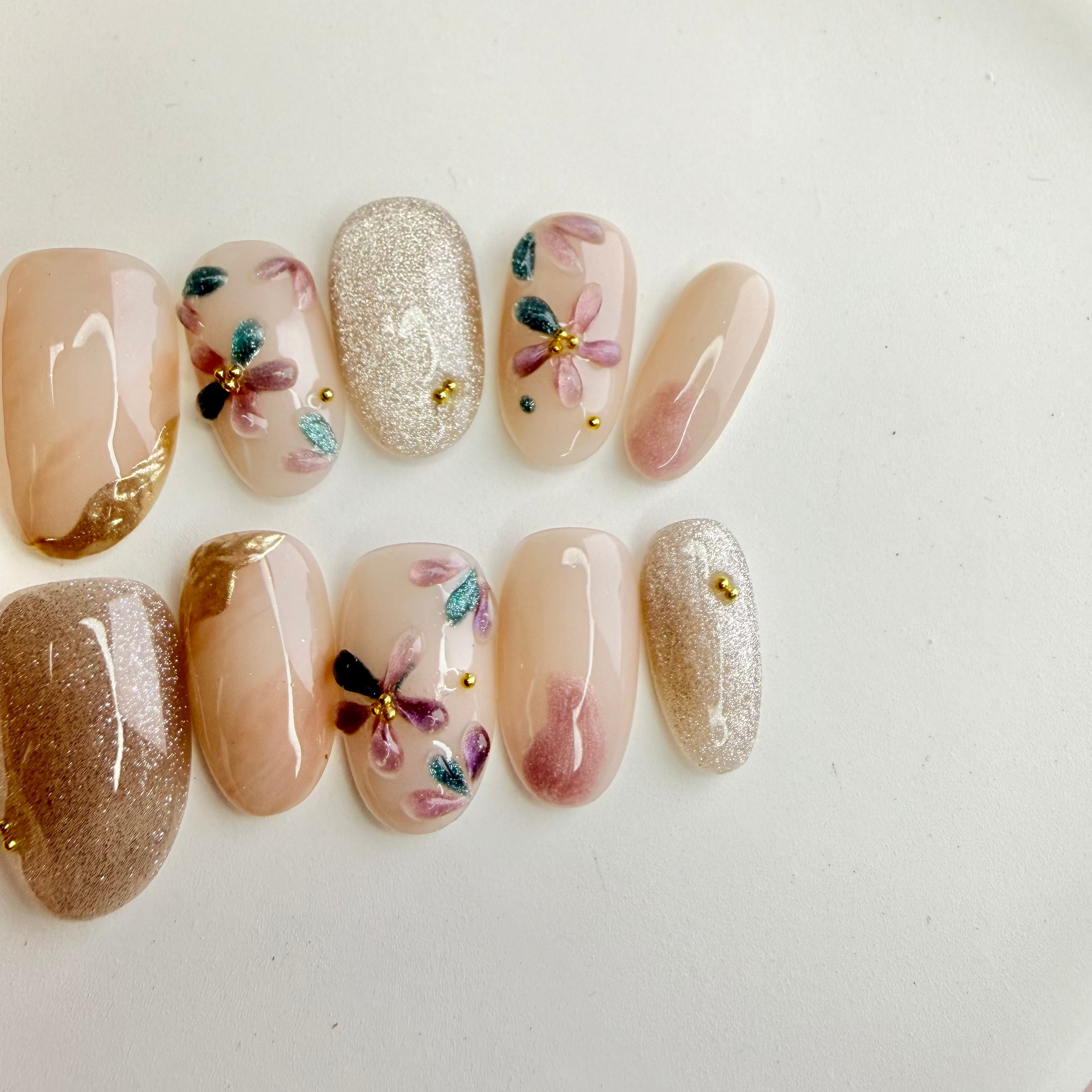 pastel flower nude press-on nails with silver glitter accent, handcrafted gel nails on white plate, Vlei Nails South Africa