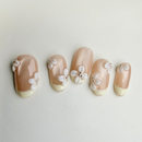 Frosted French milky-white press-on nails with frosted finish and embossed leaf texture.
