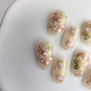 Frosty  press-on nails with white 3D flowers, gold lines and marble accents.