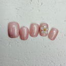 Blush pearl shimmer press-on nails with 3D white flower accents, short round