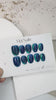 Handmade midnight blue press-on nails with glossy gel finish
