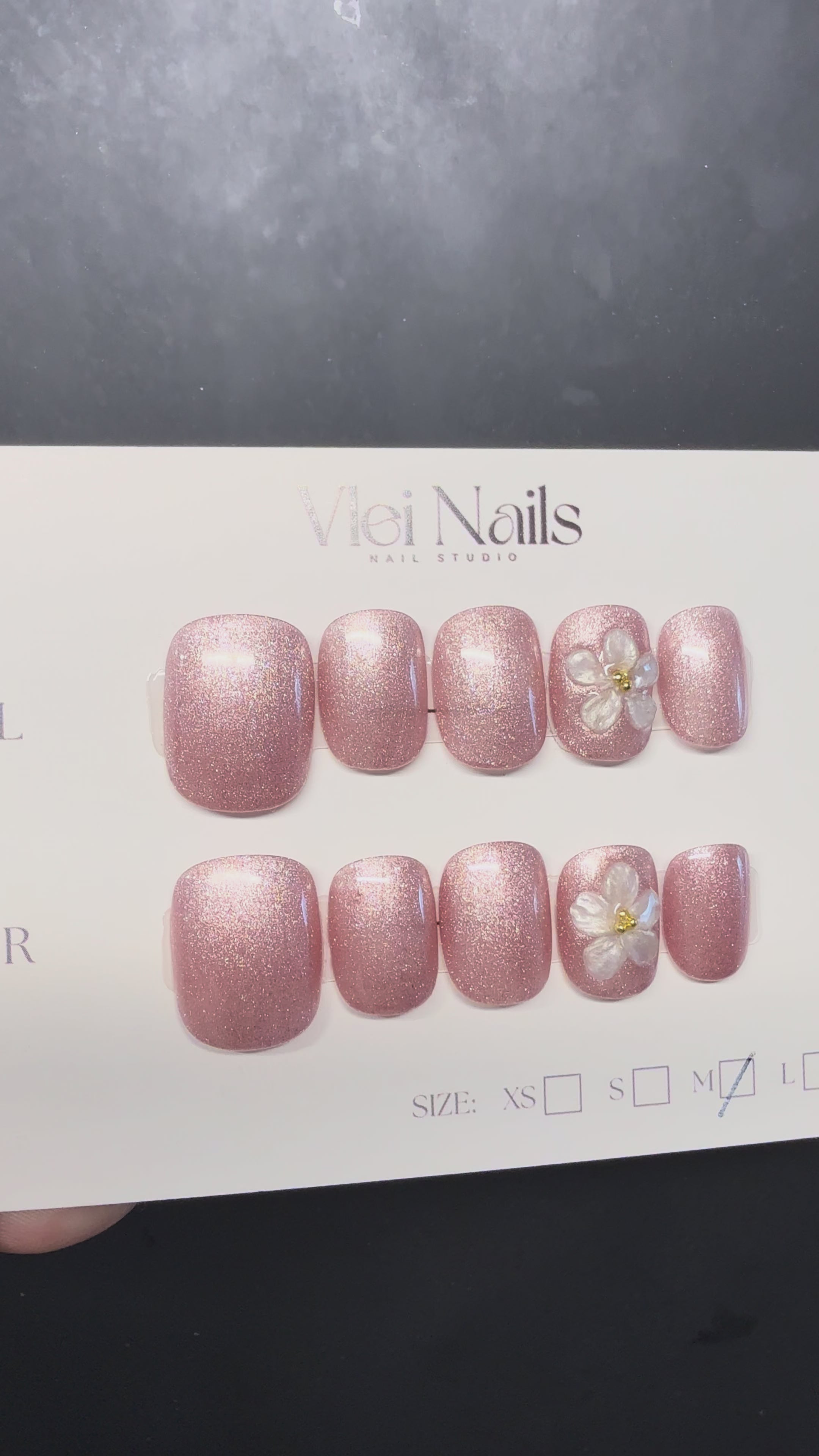Blush pearl shimmer press-on nails with 3D white flower accents, short round