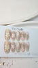 Handcrafted blush nude press-on nails with pearl flowers and gold shimmer lines – made by Vlei Nails Cape Town.

